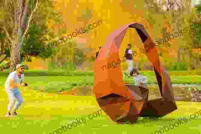 A Group Of People Admiring A Large Scale Sculpture By The Sculptress Alexander, Installed In A Public Park. The Sculptress V S Alexander