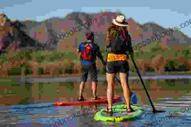 A Person Paddle Boarding On A Serene Lake, Surrounded By Stunning Nature The Power Of The Paddle